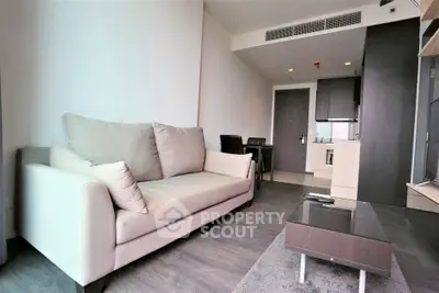 Modern living room with sleek furniture and open kitchen layout