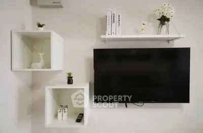 Modern living room with wall-mounted TV and stylish shelves