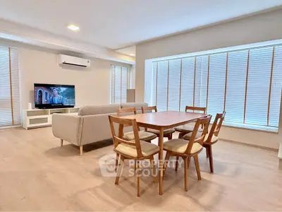 Spacious modern living room with dining area and large windows