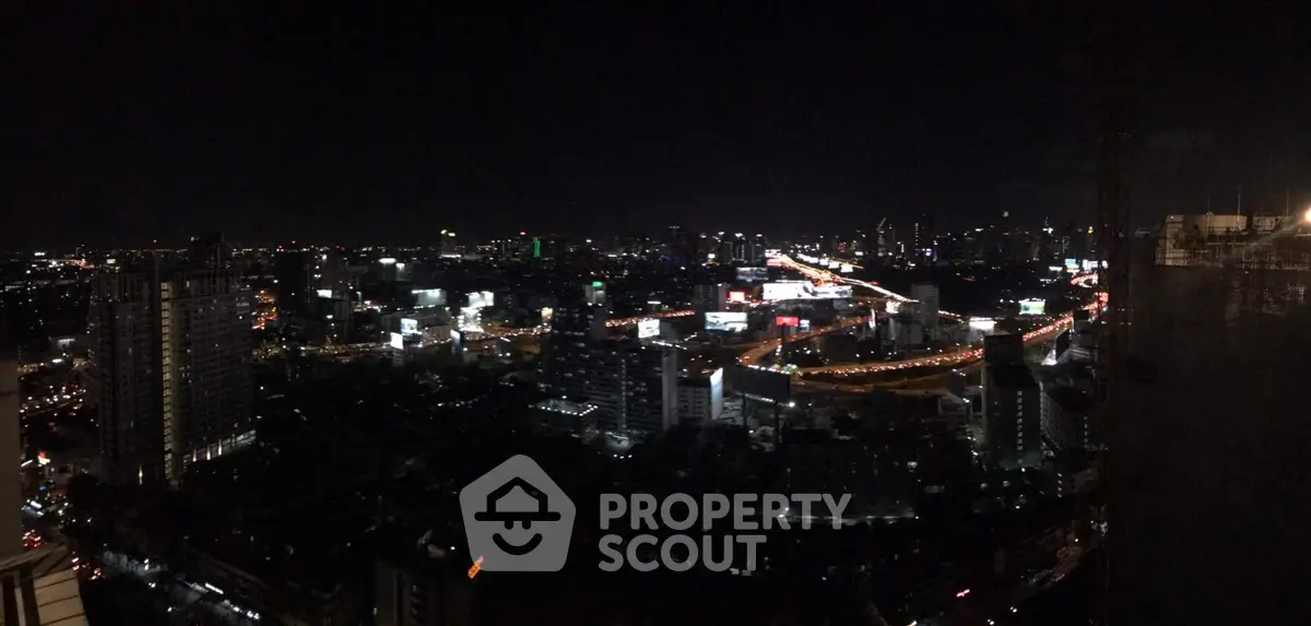 Stunning panoramic cityscape view at night showcasing vibrant urban skyline and illuminated streets.