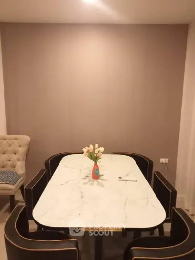 Elegant dining area with marble table and stylish chairs, perfect for modern living.