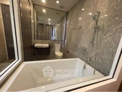Luxurious modern bathroom with marble walls and sleek fixtures