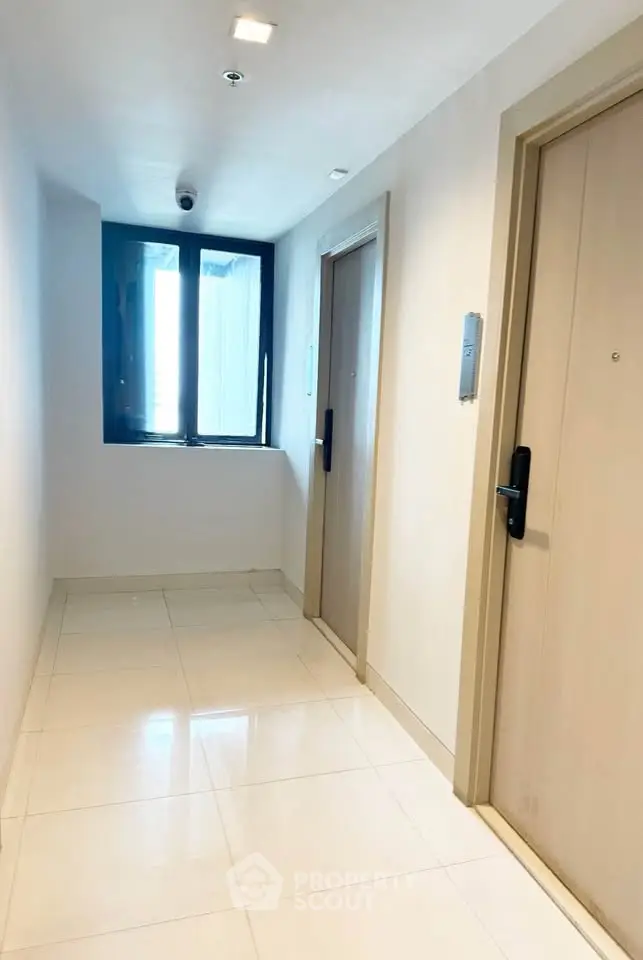 Modern apartment corridor with sleek doors and polished flooring