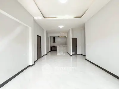 Spacious modern living room with sleek marble flooring and open layout.