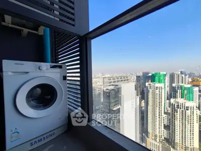 High-rise apartment with city view and washing machine on balcony