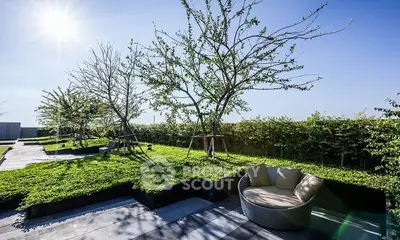 Luxurious rooftop garden with modern seating and lush greenery under a clear blue sky.