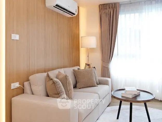 Modern living room with cozy sofa, elegant curtains, and air conditioning unit.