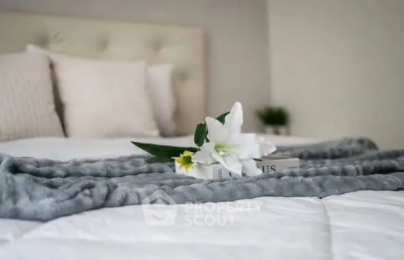 Elegant bedroom with plush bedding and stylish decor, perfect for relaxation and comfort.