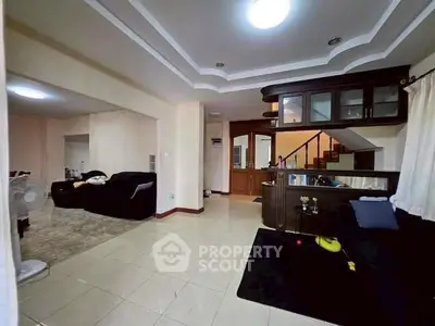 Spacious living room with modern decor and open layout, perfect for family gatherings.