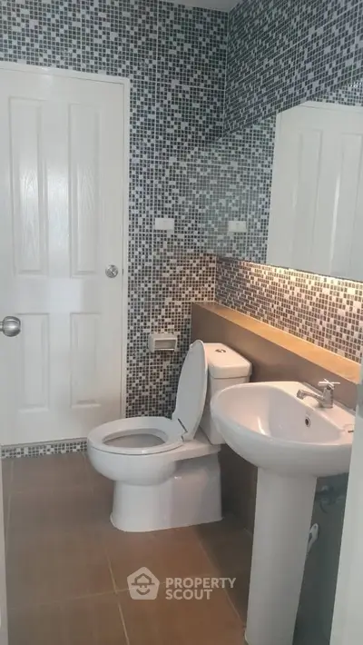 Modern bathroom with mosaic tiles and sleek fixtures