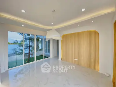 Modern living room with large windows and stylish lighting