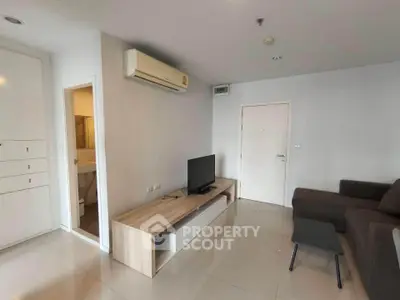 Modern living room with air conditioning and sleek furniture in a cozy apartment setting.