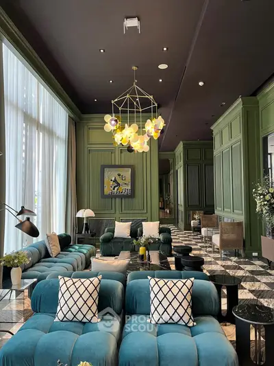 Luxurious living room with high ceilings, elegant chandelier, and plush seating in a modern green-themed decor.