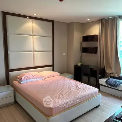 Modern bedroom with stylish decor, featuring a comfortable bed and a cozy study nook by the window.