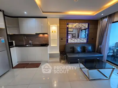 Modern open-layout living room with sleek kitchen and stylish decor