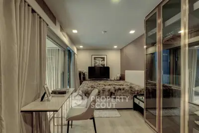 Luxurious bedroom with plush bedding, mirrored wardrobe, and elegant decor in modern apartment.
