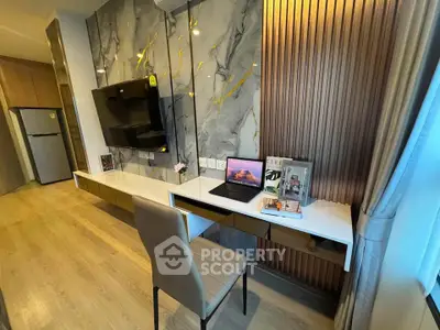 Modern study area with elegant decor and built-in desk in a stylish apartment.