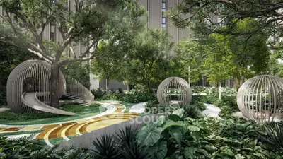 Luxurious garden with modern sculptures and lush greenery in upscale residential complex.