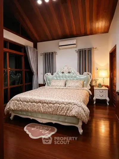 Luxurious bedroom with elegant bed and wooden ceiling, perfect for a cozy retreat.
