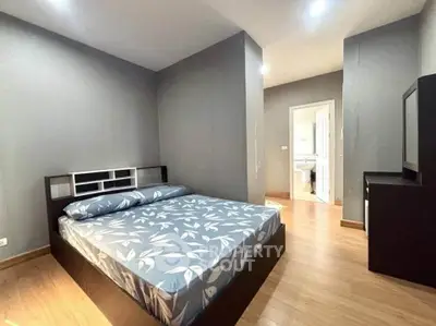 Spacious bedroom with modern decor and ensuite bathroom in a stylish apartment.