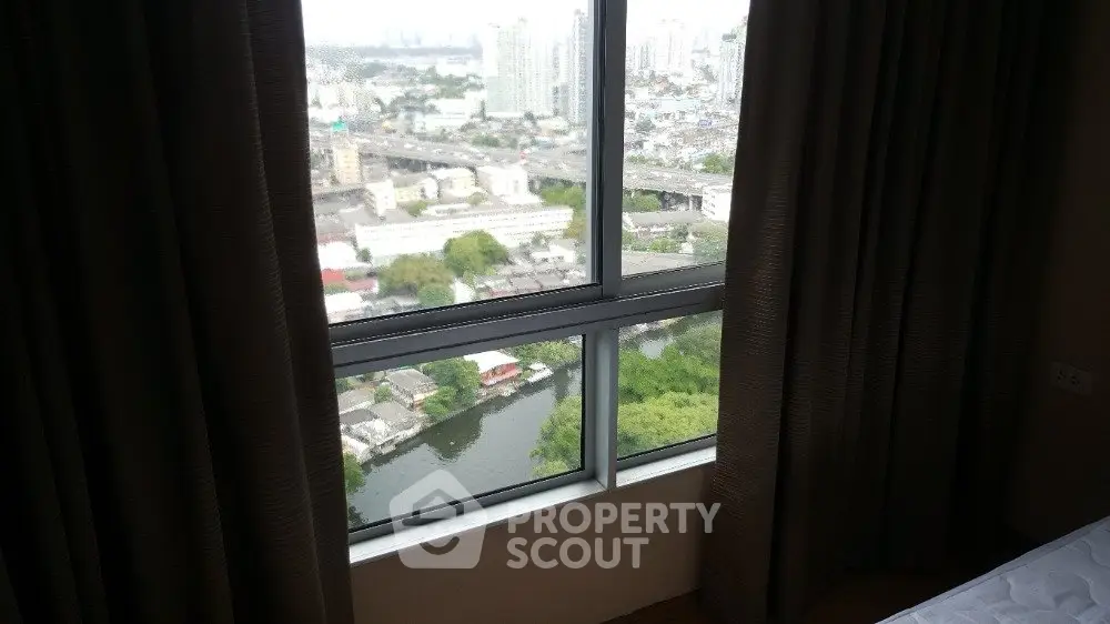 Stunning high-rise apartment view with cityscape and river panorama.