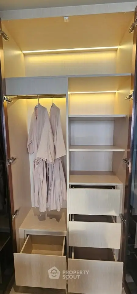 Spacious walk-in closet with ample shelving and hanging space, perfect for organized storage.
