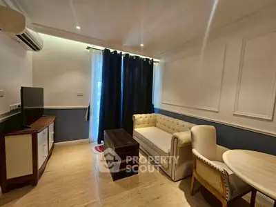 Charming living room with elegant furniture and natural light, perfect for relaxation and entertainment.