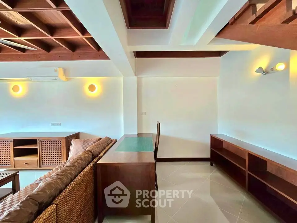 Spacious living room with modern wooden furniture and stylish ceiling design.