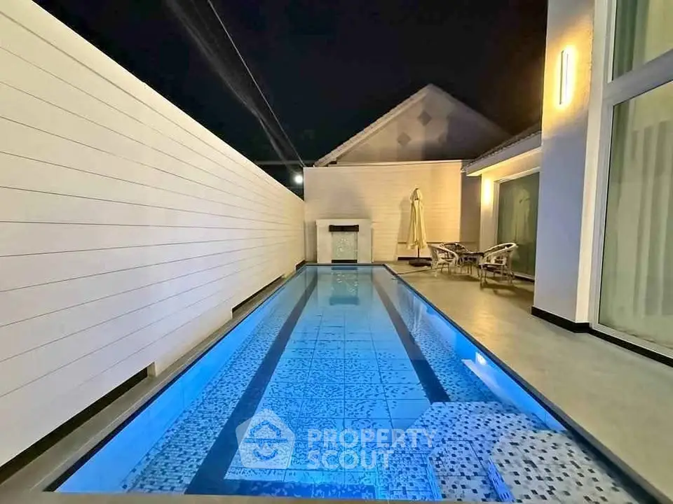 Luxurious night view of a modern private swimming pool with elegant lighting.