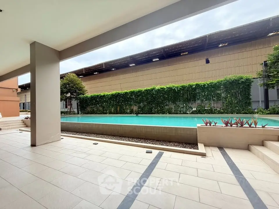 Luxurious poolside view with modern design and lush greenery, perfect for relaxation and leisure.