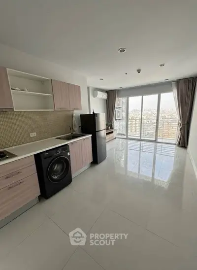Modern kitchen with sleek appliances and city view from large windows