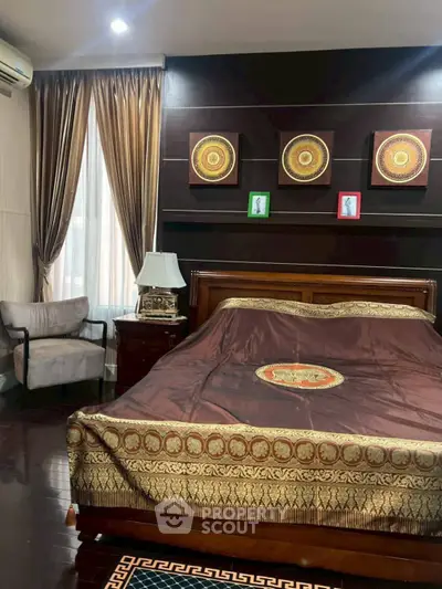 Luxurious bedroom with elegant decor and rich wooden furnishings