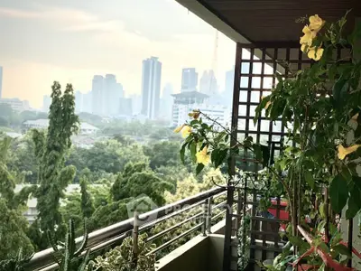 Lush balcony with city skyline view, perfect for urban gardening enthusiasts.