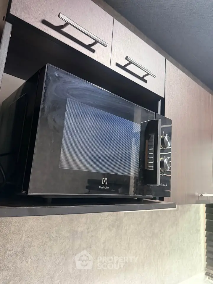 Modern kitchen with sleek microwave in stylish cabinetry