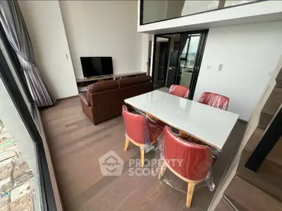 Spacious modern living room with dining area and large windows