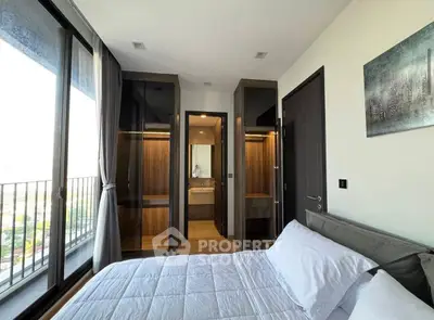 Modern bedroom with balcony view and walk-in closet in luxury apartment