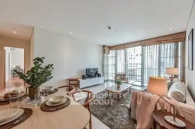 Spacious modern living room with elegant decor and large windows offering city views.