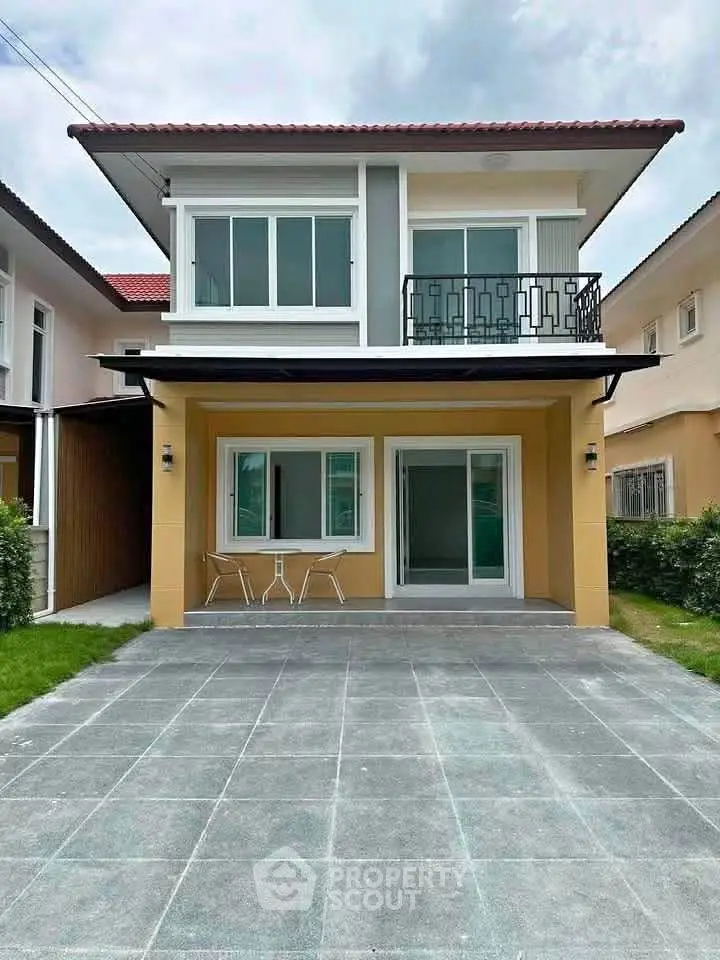 Modern two-story house with balcony and spacious driveway