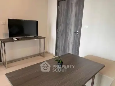 Modern living room with sleek furniture and a flat-screen TV, perfect for relaxation and entertainment.