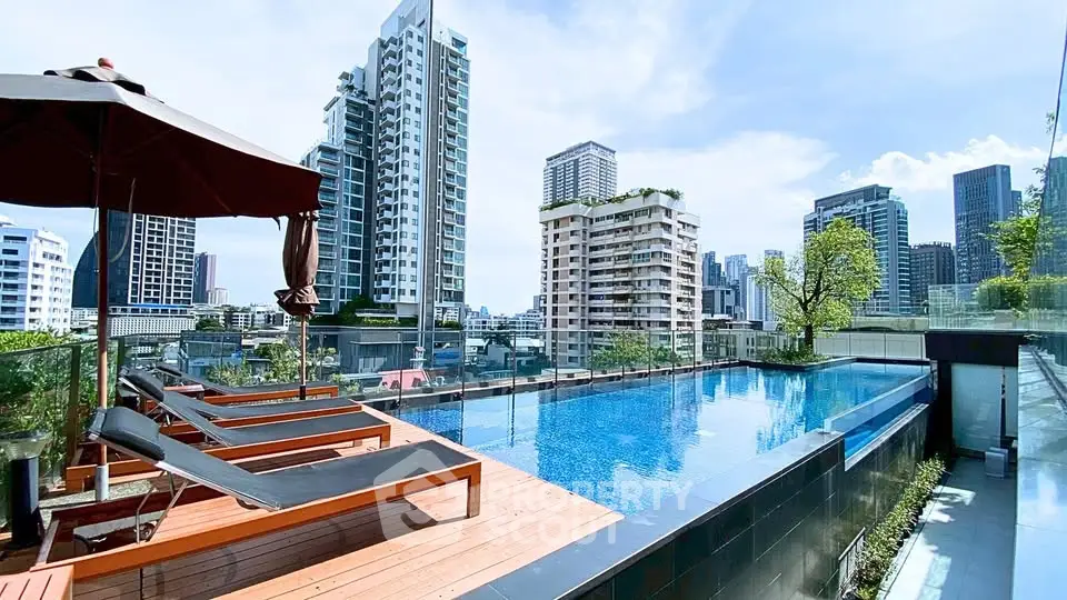 Luxurious rooftop pool with stunning city skyline views in modern urban setting.