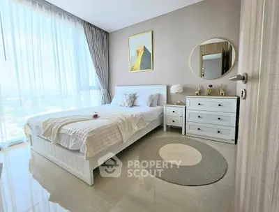 Bright and airy bedroom with large window and modern decor