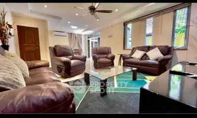 Spacious living room with leather sofas and modern decor