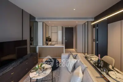 Modern living room with sleek design, featuring a cozy sofa, stylish decor, and a contemporary open kitchen layout.