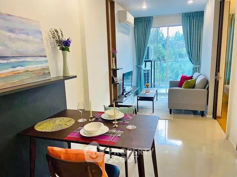 Modern living room with dining area and balcony view, featuring stylish decor and natural light.