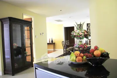 Elegant living room with stylish decor and fruit display, showcasing a sophisticated interior design.