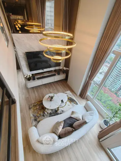 Luxurious modern living room with high ceilings, elegant lighting, and large windows offering stunning city views.