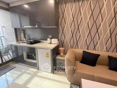 Modern compact kitchen with stylish sofa and geometric wallpaper