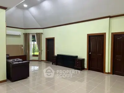 Spacious living room with high ceiling and elegant furniture