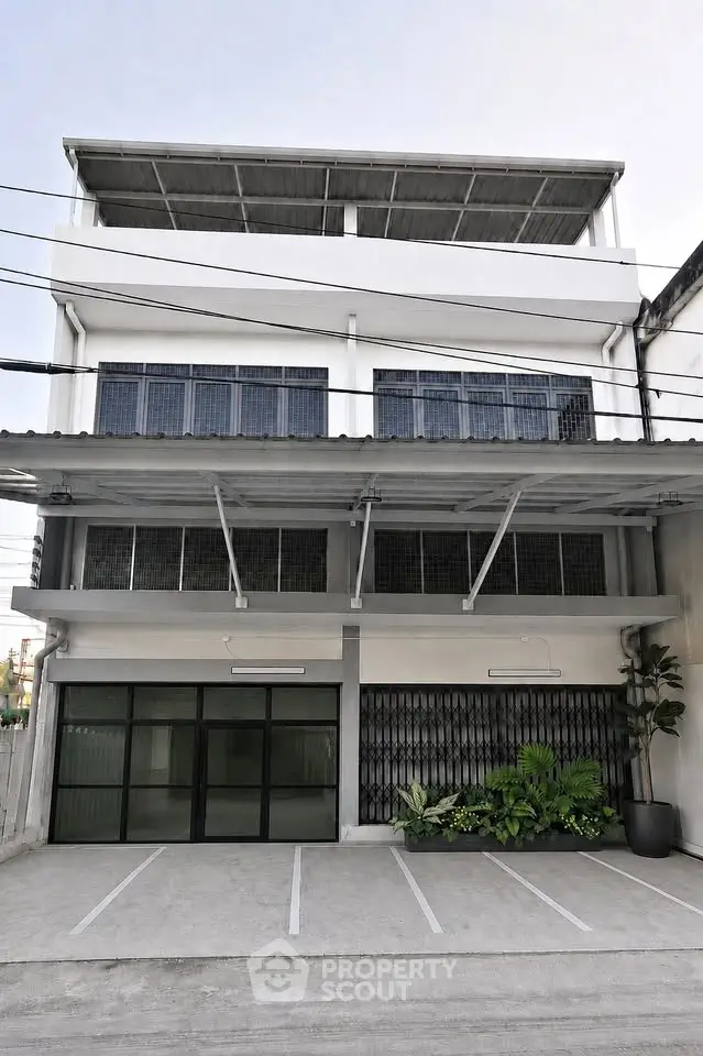 Modern commercial building exterior with parking space and large windows
