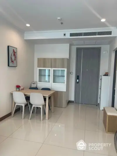 Modern dining area with sleek furniture and stylish decor in a contemporary apartment.